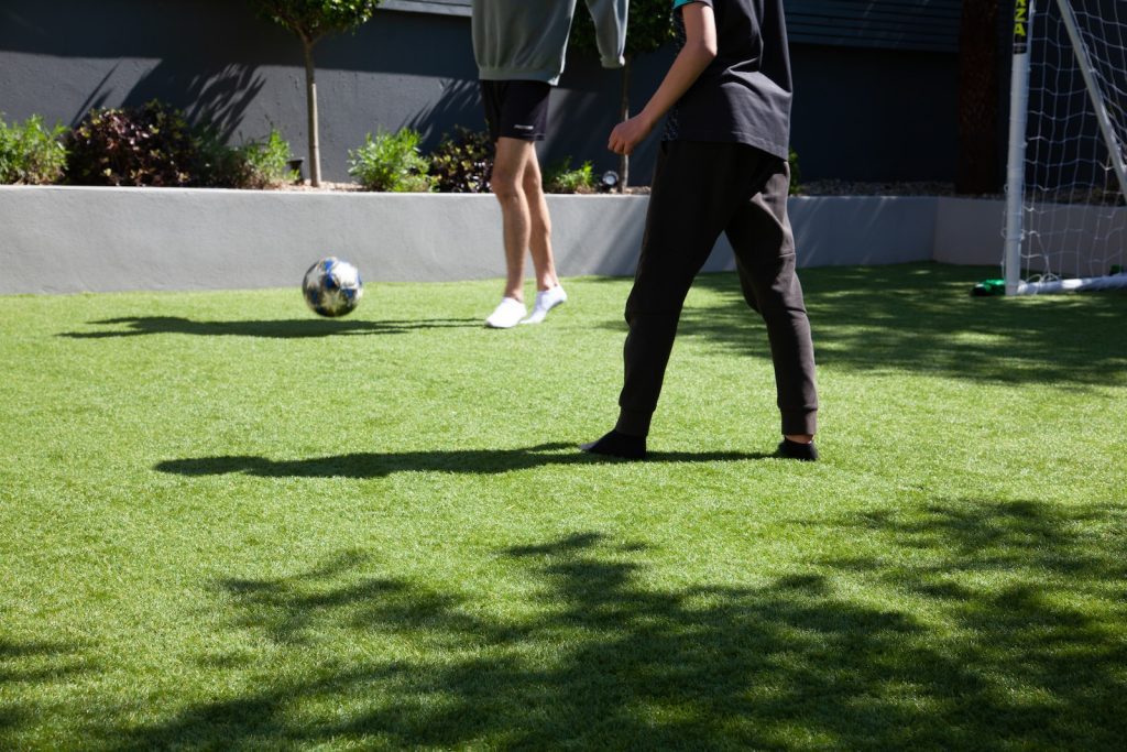 man in blue and white soccer jersey playing soccer